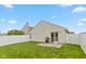 Fenced backyard with manicured lawn, concrete patio, and plenty of space for outdoor activities at 2623 Santaro Ct, Indianapolis, IN 46217