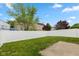 Large, fenced backyard with lush lawn and mature trees providing shade and privacy at 2623 Santaro Ct, Indianapolis, IN 46217