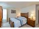 Comfortable bedroom with a neatly made queen-sized bed and matching wooden nightstands and dressers at 2623 Santaro Ct, Indianapolis, IN 46217