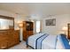 Cozy bedroom featuring a wooden dresser, media center, and a queen-sized bed with blue striped bedding at 2623 Santaro Ct, Indianapolis, IN 46217