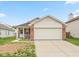 Charming single Gathering home with a brick facade, attached two-car garage and manicured lawn at 2623 Santaro Ct, Indianapolis, IN 46217