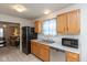 Bright kitchen with stainless steel appliances, wood cabinets, and a double basin sink at 2623 Santaro Ct, Indianapolis, IN 46217