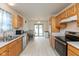 Bright kitchen with stainless steel appliances, wood cabinetry, and modern lighting at 2623 Santaro Ct, Indianapolis, IN 46217