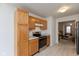 Well-lit kitchen featuring stainless steel appliances and abundant wood cabinet space at 2623 Santaro Ct, Indianapolis, IN 46217
