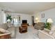 Spacious living room filled with comfortable seating, neutral carpet, and large windows at 2623 Santaro Ct, Indianapolis, IN 46217