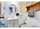 Bathroom with vanity sink, round mirror, grab bar and handicap accessible toilet at 2625 N Boehning St, Indianapolis, IN 46219