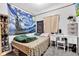 Well-lit bedroom with textured walls, comfortable bed, a desk and whimsical decor at 2625 N Boehning St, Indianapolis, IN 46219