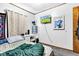 Bright bedroom with TV, white desk, vibrant decor, and lots of natural light at 2625 N Boehning St, Indianapolis, IN 46219
