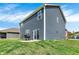 Backyard view featuring a patio with a grill, a well-kept lawn, and blue siding on this two story home at 2972 W Patchwork Dr, Monrovia, IN 46157