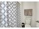 Well-lit bathroom with a decorative shower curtain and toilet at 2972 W Patchwork Dr, Monrovia, IN 46157