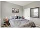 Comfortable bedroom offers gray walls, carpet, a bed with gray bedding, and a window for natural light at 2972 W Patchwork Dr, Monrovia, IN 46157