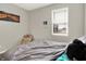 Cozy bedroom with gray walls, carpeted floors, a plush bed, and a window providing natural light at 2972 W Patchwork Dr, Monrovia, IN 46157
