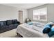 Bedroom features a queen size bed, grey walls, couch, and natural light at 2972 W Patchwork Dr, Monrovia, IN 46157
