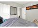 This bedroom features gray walls, carpet, a bed with gray bedding, and convenient closet access at 2972 W Patchwork Dr, Monrovia, IN 46157