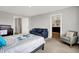 Bedroom features a queen size bed, grey walls, a couch, and view into en suite at 2972 W Patchwork Dr, Monrovia, IN 46157