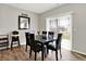 Sunlit dining area features a black dining set and sliding glass doors to the yard at 2972 W Patchwork Dr, Monrovia, IN 46157