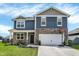 Charming two-story home featuring blue siding, stone accents, a two-car garage, and a basketball hoop at 2972 W Patchwork Dr, Monrovia, IN 46157