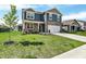 Beautiful two-story home with a well-manicured lawn, a two-car garage, and a lovely tree at 2972 W Patchwork Dr, Monrovia, IN 46157