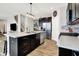 Modern kitchen boasts stainless steel appliances, dark cabinetry and center island with pendant lighting at 2972 W Patchwork Dr, Monrovia, IN 46157