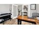 Home office featuring a piano, glass french doors, and wood flooring for a professional workspace at 2972 W Patchwork Dr, Monrovia, IN 46157