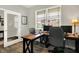 Bright office space with a large window, wooden desk, rolling chairs, and glass french doors at 2972 W Patchwork Dr, Monrovia, IN 46157