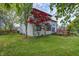View of home's rear exterior, deck, and spacious backyard at 305 Cardinal Dr, Whiteland, IN 46184