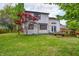 The home has a deck and a spacious backyard with a tree at 305 Cardinal Dr, Whiteland, IN 46184