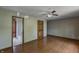 Bedroom with hardwood floors, a ceiling fan, and an en-suite bathroom, providing comfort and convenience at 305 Cardinal Dr, Whiteland, IN 46184