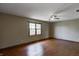 Bright bedroom with hardwood floors, a ceiling fan, and a large window, perfect for relaxation at 305 Cardinal Dr, Whiteland, IN 46184
