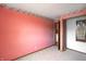 Bright bedroom features neutral carpet, pink walls, and open doorway to another room at 305 Cardinal Dr, Whiteland, IN 46184