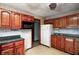 The kitchen features wood cabinets and black appliances, providing ample storage and cooking space at 305 Cardinal Dr, Whiteland, IN 46184