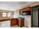 This kitchen features dark wood cabinets, providing warmth and functionality at 305 Cardinal Dr, Whiteland, IN 46184
