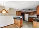 Vintage eat-in kitchen featuring wood cabinets, an island with seating, and durable countertops at 305 Cardinal Dr, Whiteland, IN 46184