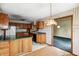 Cozy kitchen with wood cabinets, a black countertop and a bright window overlooking the dining room at 305 Cardinal Dr, Whiteland, IN 46184