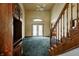 Spacious living room with high ceilings, a ceiling fan, carpet, and access to the backyard through glass doors at 305 Cardinal Dr, Whiteland, IN 46184