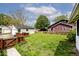 A verdant backyard featuring a detached garage, framed by a rustic wood fence at 312 S Center St, Plainfield, IN 46168