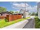 A view of the home's exterior, featuring a well-maintained driveway and backyard with wood fence at 312 S Center St, Plainfield, IN 46168