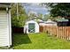 A wooden shed is nestled in a backyard, bordered by a rustic wood fence at 312 S Center St, Plainfield, IN 46168