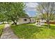 A charming house with a gazebo, nestled in a lush green lawn with mature trees at 312 S Center St, Plainfield, IN 46168
