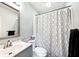 Bright bathroom features a modern vanity, toilet and a shower with stylish curtain at 312 S Center St, Plainfield, IN 46168