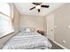 Comfortable bedroom with ceiling fan, window with blinds, and patterned bedspread at 312 S Center St, Plainfield, IN 46168