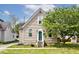 Charming home featuring a classic exterior and a beautiful, mature tree in the front yard at 312 S Center St, Plainfield, IN 46168