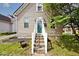 Welcoming front entrance with a vibrant green door and well-maintained landscaping at 312 S Center St, Plainfield, IN 46168