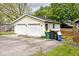 Detached two-car garage with white doors and siding and a double-wide parking pad at 312 S Center St, Plainfield, IN 46168