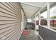 A side porch is shown with a covered space and wood framing with neutral colored siding at 312 S Center St, Plainfield, IN 46168