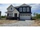 Charming two-story home featuring navy siding, white trim, and a spacious two-car garage at 3932 Andean Ct, Bargersville, IN 46106