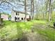 Expansive backyard featuring a patio, deck, and large grassy area at 4223 Kestrel Ct, Indianapolis, IN 46254