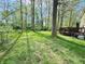 Expansive backyard with mature trees, a hot tub, and plenty of green space for outdoor enjoyment at 4223 Kestrel Ct, Indianapolis, IN 46254