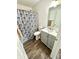 Bathroom with a blue floral shower curtain and gray vanity at 4223 Kestrel Ct, Indianapolis, IN 46254
