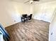 A bright bedroom with wood-look flooring, ceiling fan, and large window at 4223 Kestrel Ct, Indianapolis, IN 46254